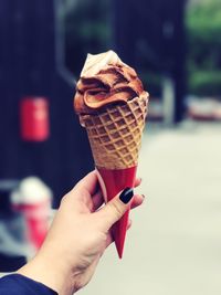 Cropped hand of woman holding ice cream cone