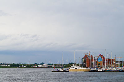 Sailboats in sea against sky