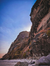 Low angle view of rock formations against sky