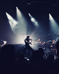 People playing guitar at music concert