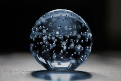 Close-up of wet glass on table