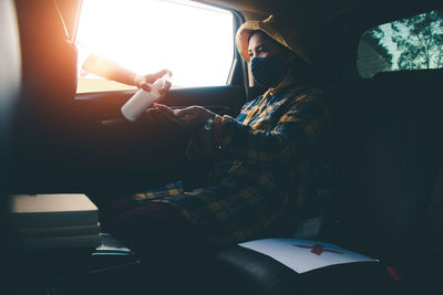 High angle view of woman sitting in car