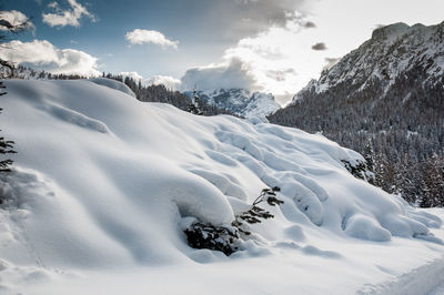 Scenic view of snow covered mountains against sky