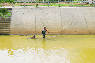 Full length of man fishing in lake