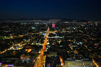 High angle view of illuminated buildings in city at night