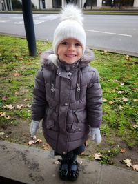 Portrait of smiling girl standing in winter