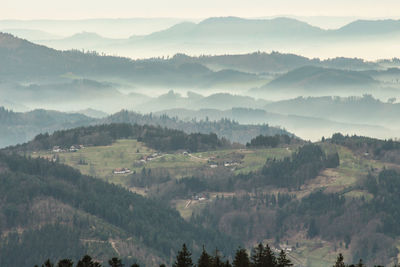 A mysterious landscape of mountains shrouded in fog and towering over the mummelsee in germany