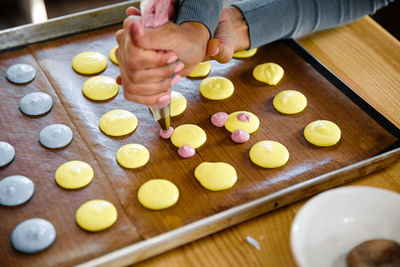 Midsection of person preparing food on cutting board