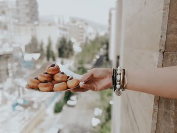 Midsection of woman holding cakes 