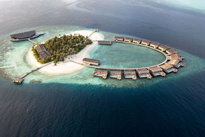 Maldives, lhaviyani atoll, kudadoo island, aerial view of island tourist resort surrounded by indian ocean