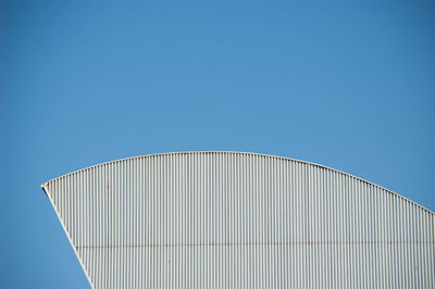 Low angle view of water tower against clear blue sky