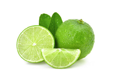 Close-up of green fruit against white background