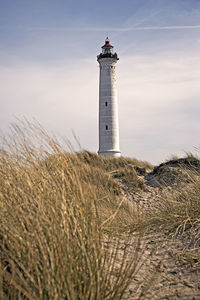 Lighthouse on land against sky