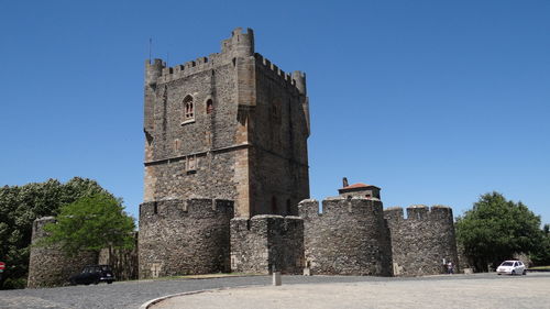 Low angle view of historic building against clear blue sky