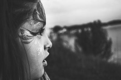 Profile view of girl with make-up looking away