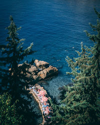 Antalya, turkey 6th october 2019 people sunbathing by the sea on the rocks. image from above.