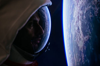 Close-up of astronaut looking at earth from outer space