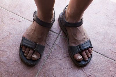 Low section of man standing on footpath