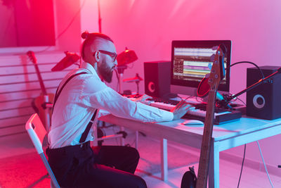 Side view of man working on table