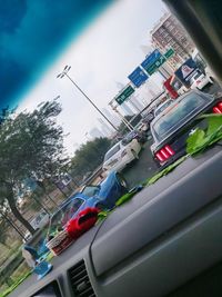 Cars on road in city against sky