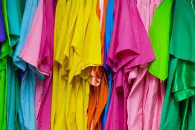 Colorful clothes hanging for sale in store