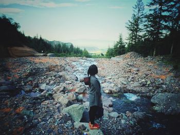 Full length of woman standing on rock