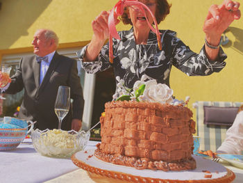 Senior woman looking at cake