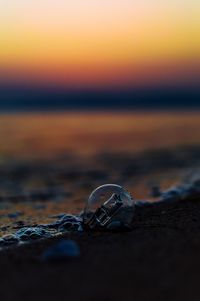 Close-up of sea against sunset sky