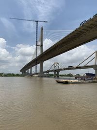 Low angle view of suspension bridge against sky