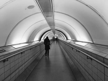 Rear view of man walking in subway