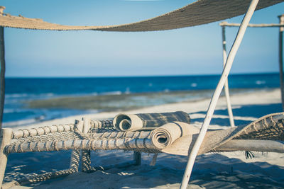 Close-up of camp beds on beach