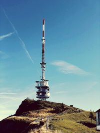 Low angle view of communications tower against sky