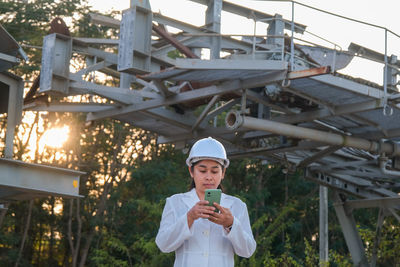 Portrait of young woman standing in factory