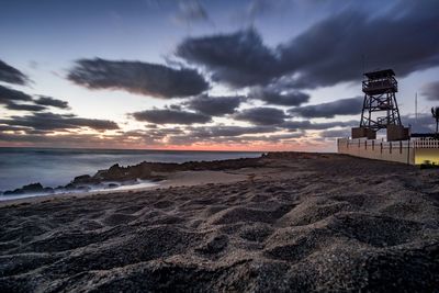 Scenic view of beach against sky during sunset