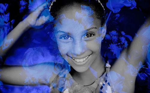 Close-up portrait of smiling woman with purple flowers