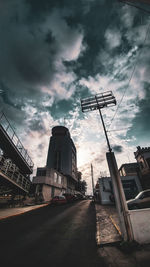 Low angle view of street amidst buildings against sky