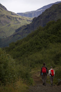 Couple walking through a valley on the laugavegur trail