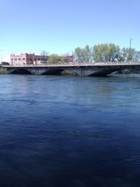 Calm river with buildings in background