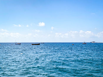 Scenic view of sea against blue sky