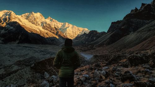 Rear view of man standing on mountain