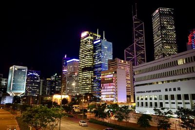 Illuminated cityscape against sky at night