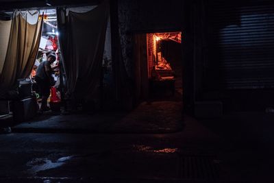 Man standing in illuminated building