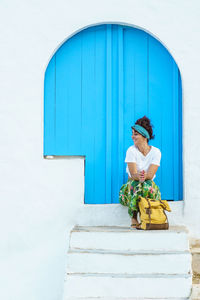 Isolated cheerful woman on holidays in europe. woman on the stairs on spanish travel destination.