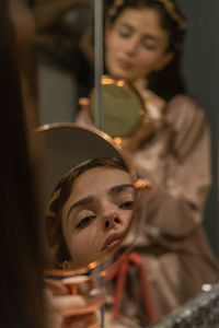 Portrait reflexión of young woman in bathroom