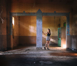 Full length of woman standing in corridor