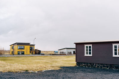 Houses on field against sky