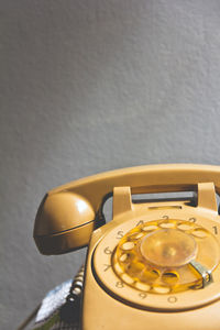 Close up of telephone on table against wall