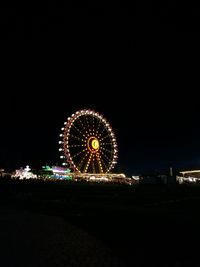 Ferris wheel against sky at night