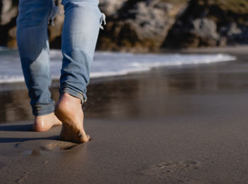 Man walking barefoot on the beach