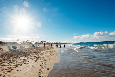 People on beach against sky